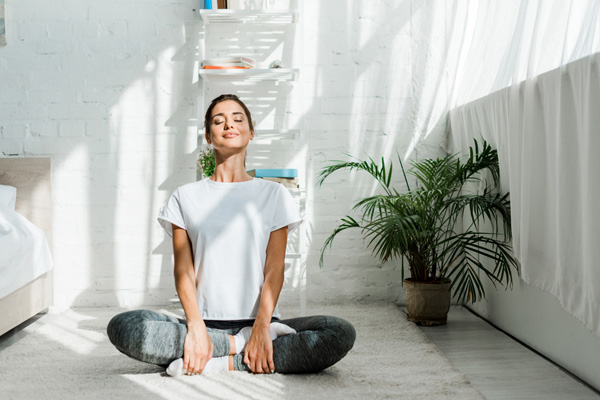 homeowner doing yoga depicting air conditioning health effects