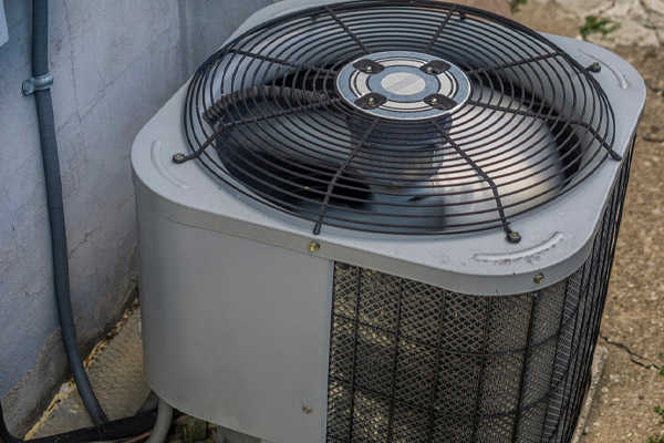 air conditioner condenser fan outside of a home