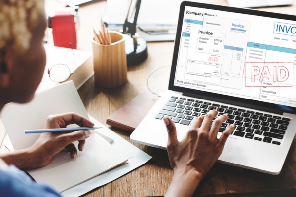 woman settling invoice depicting pricing and payment options for fuel oil