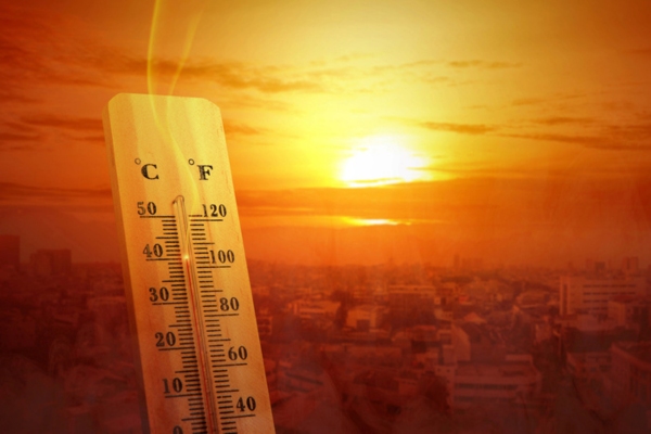 summer sun and thermometer depicting warm temperature and home heating oil