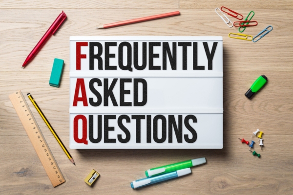 Frequently asked questions written on lightbox depicting HVAC blower FAQs