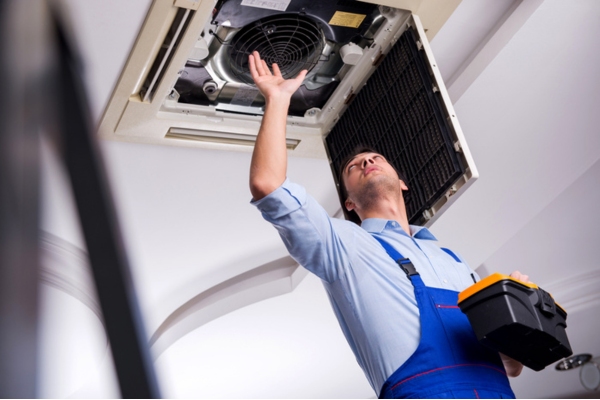 HVAC technician doing repair on indoor unit