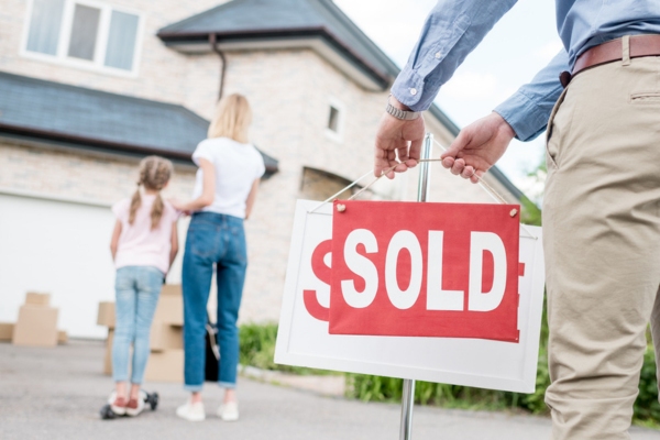 mom and daughter looking at sold house depicting increased property value due to generator