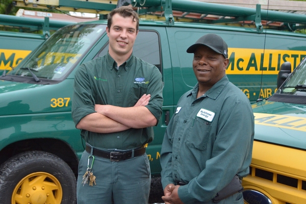 McAllister Energy HVAC technicians in front of service vans