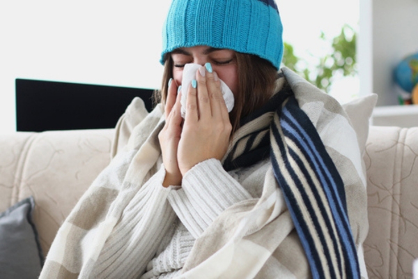 woman feeling cold indoors due to frozen heating oil