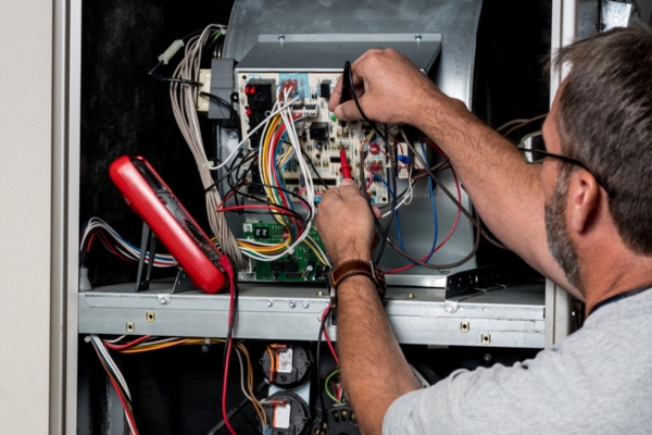 hvac contractor working on a malfunctioning furnace