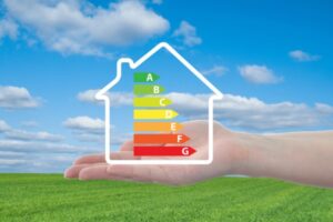 hand holding a heating efficiency scale on a house outline depicting AFUE and AFUE2