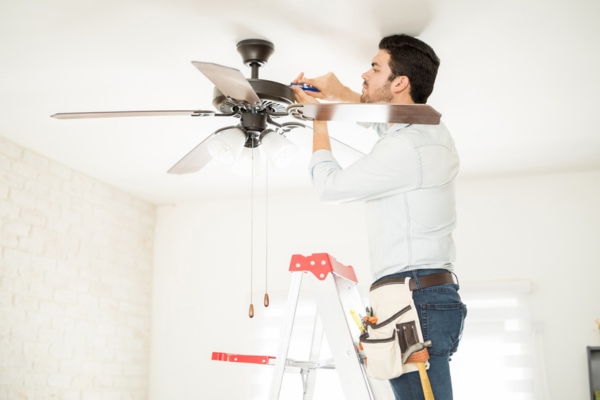 handyman installing ceiling fan